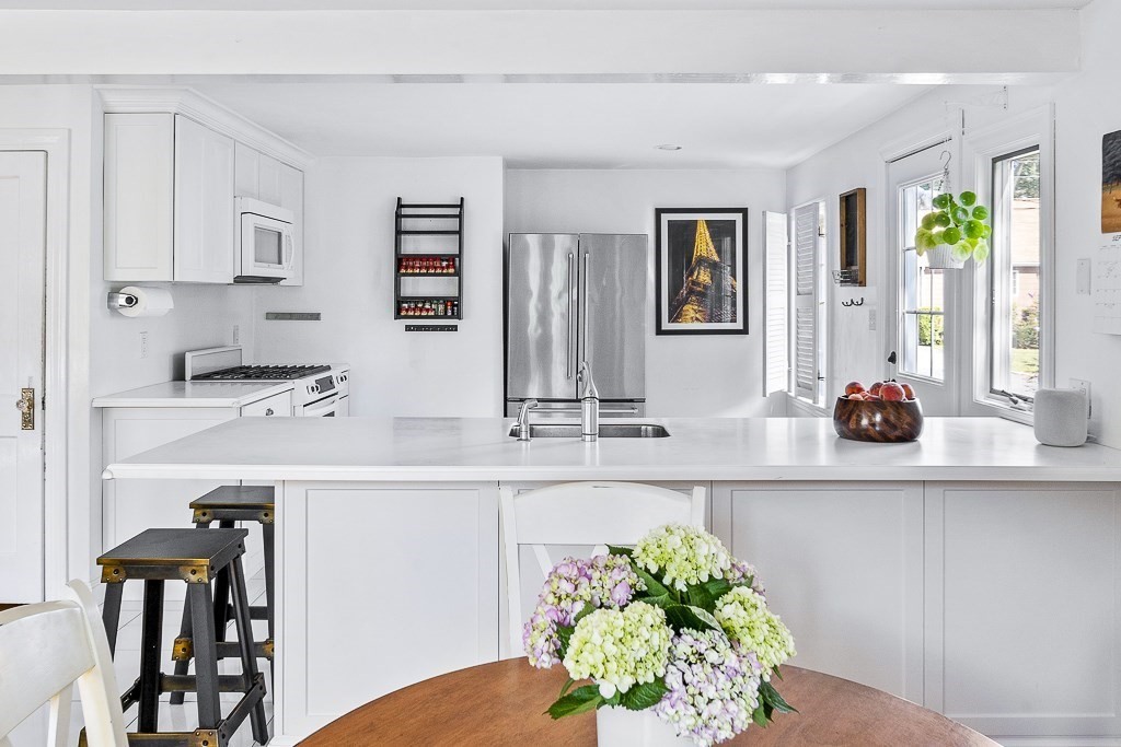 28 Longmeadow Road Arlington, MA 02474 - Photo 9 of 25 a view of kitchen with stainless steel appliances kitchen island granite countertop a sink and cabinets