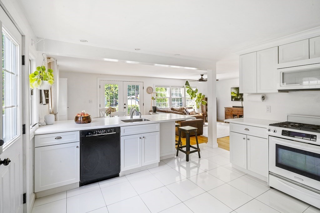 28 Longmeadow Road Arlington, MA 02474 - Photo 10 of 25 a kitchen with a stove a sink and a refrigerator