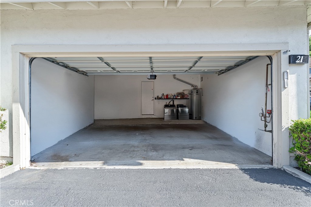 5847 East Rocking Horse Way, Unit 21 Orange, CA 92869 - Photo 45 of 54 This photo has been digitally edited to remove personal belongings and depict the garage as an empty space for illustrative purposes only.