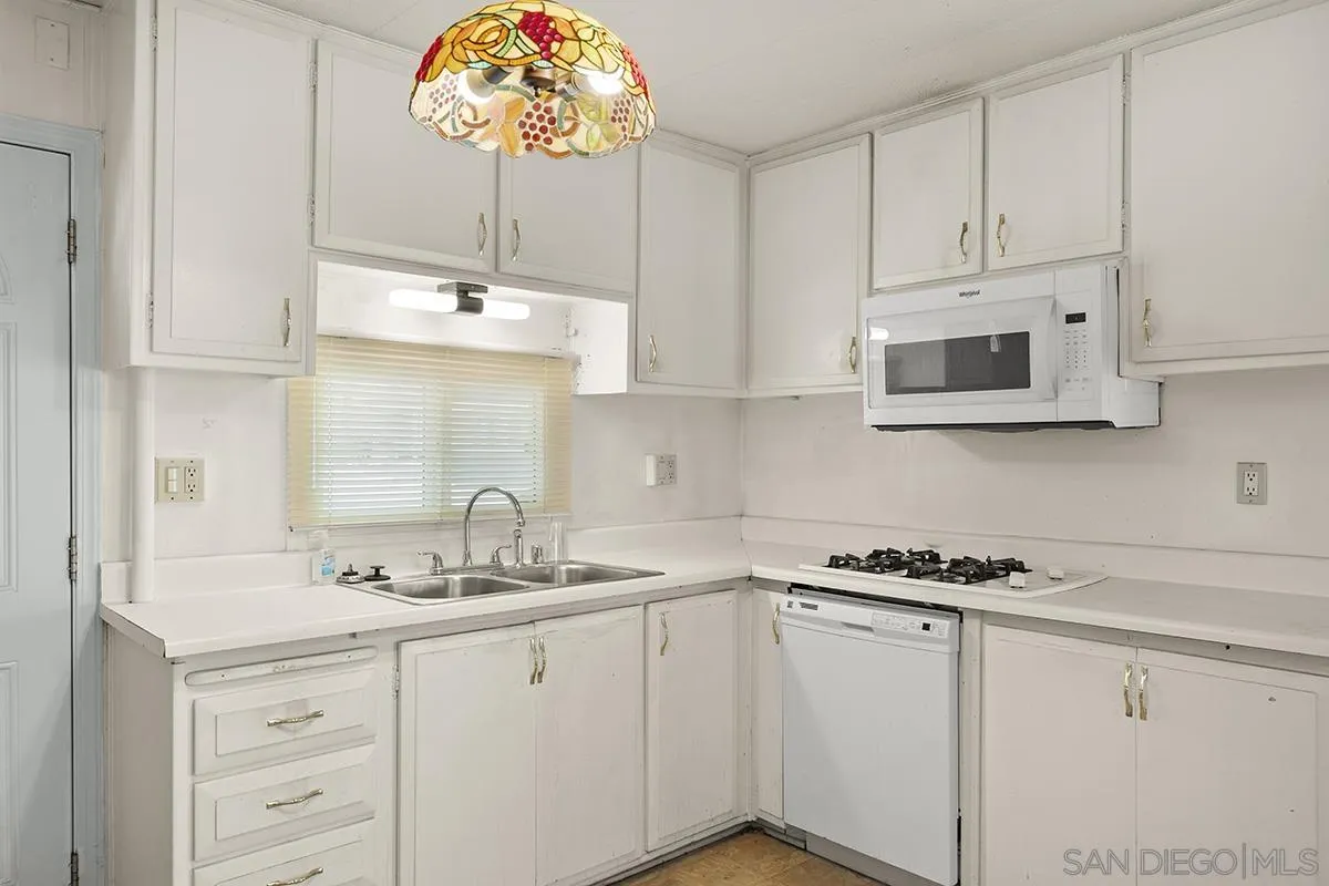 8545 Mission Gorge Road, Unit 239 Santee, CA 92071 - Photo 12 of 26 a kitchen with cabinets a window and a sink