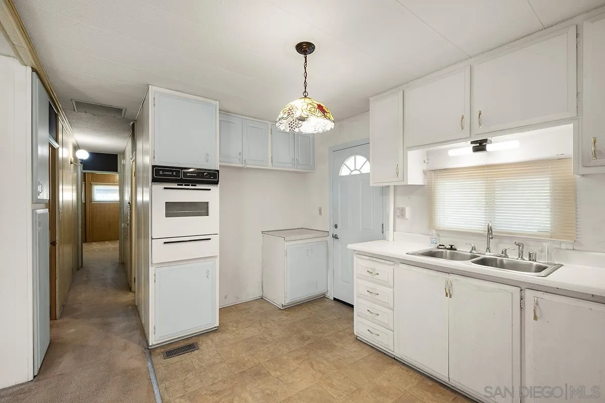 8545 Mission Gorge Road, Unit 239 Santee, CA 92071 - Photo 14 of 26 a kitchen with a sink and refrigerator