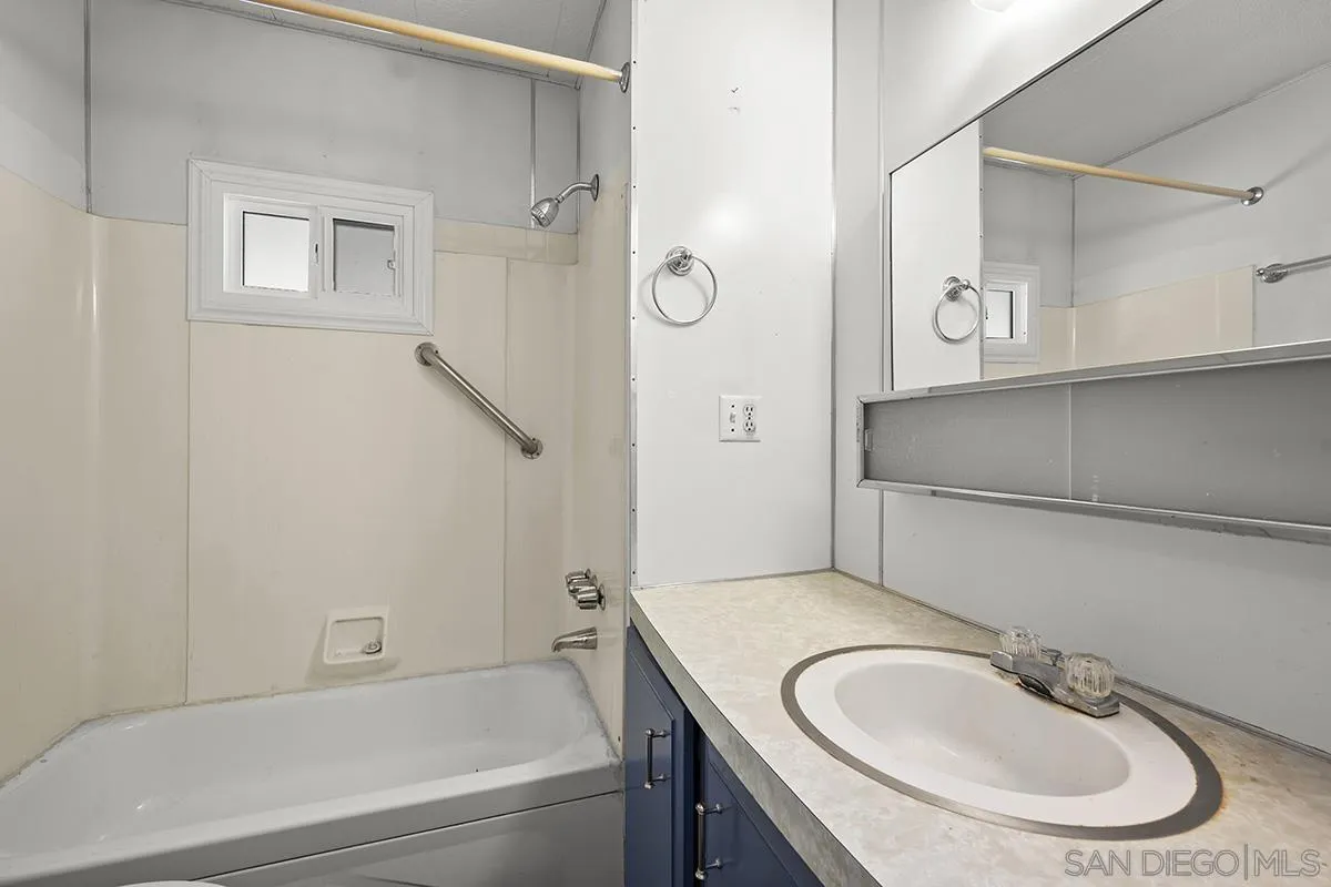 8545 Mission Gorge Road, Unit 239 Santee, CA 92071 - Photo 15 of 26 a bathroom with a granite countertop sink and a mirror