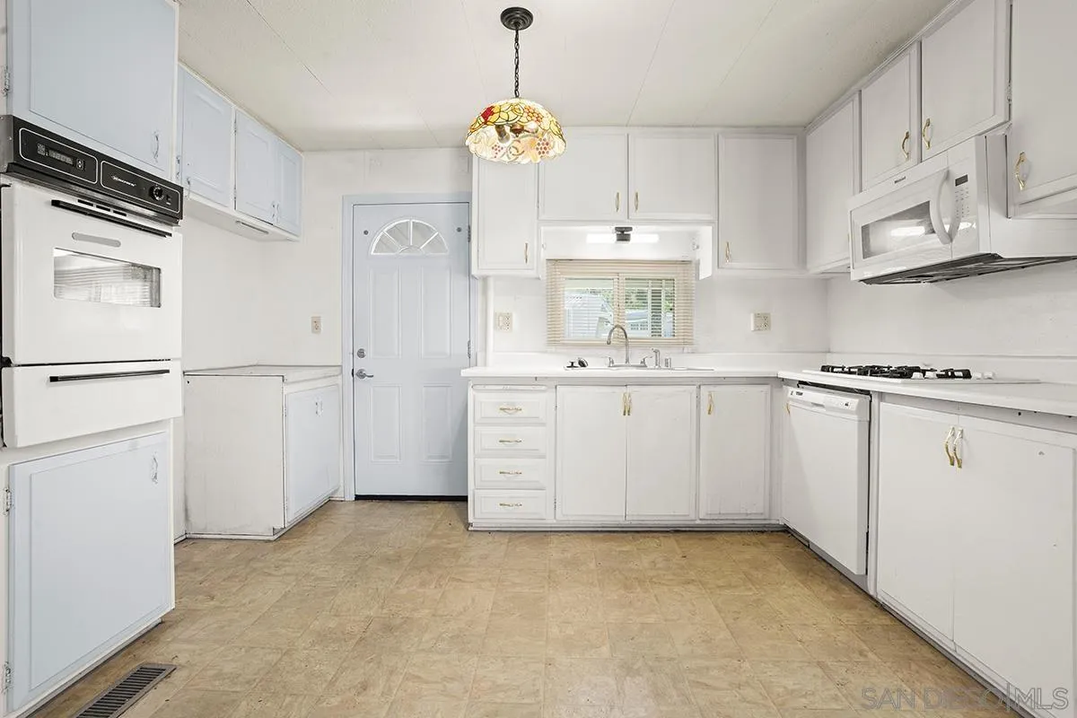 8545 Mission Gorge Road, Unit 239 Santee, CA 92071 - Photo 20 of 26 a kitchen with cabinets and window