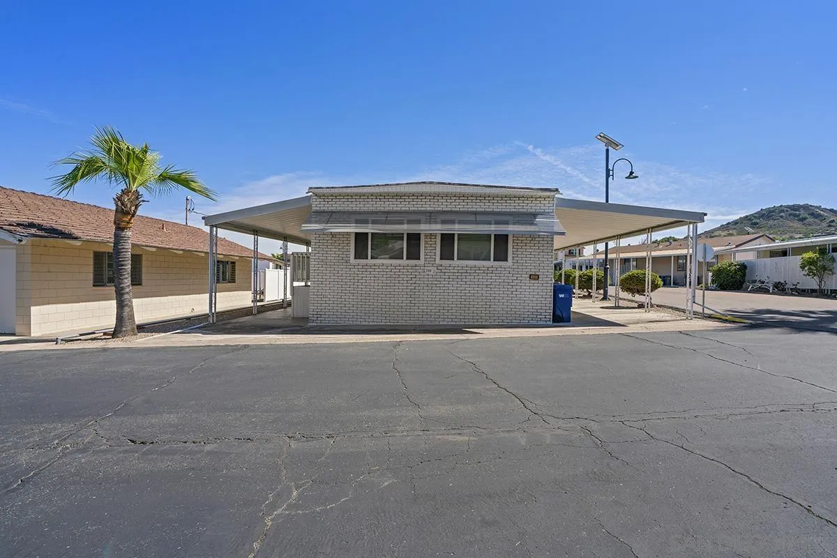 8545 Mission Gorge Road, Unit 239 Santee, CA 92071 - Photo 2 of 26 a front view of a house with a yard and garage