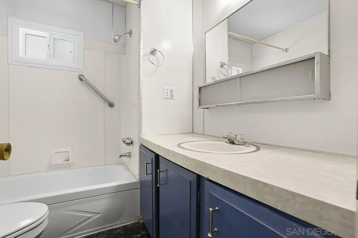 8545 Mission Gorge Road, Unit 239 Santee, CA 92071 - Photo 21 of 26 a bathroom with a sink a toilet and a bathtub