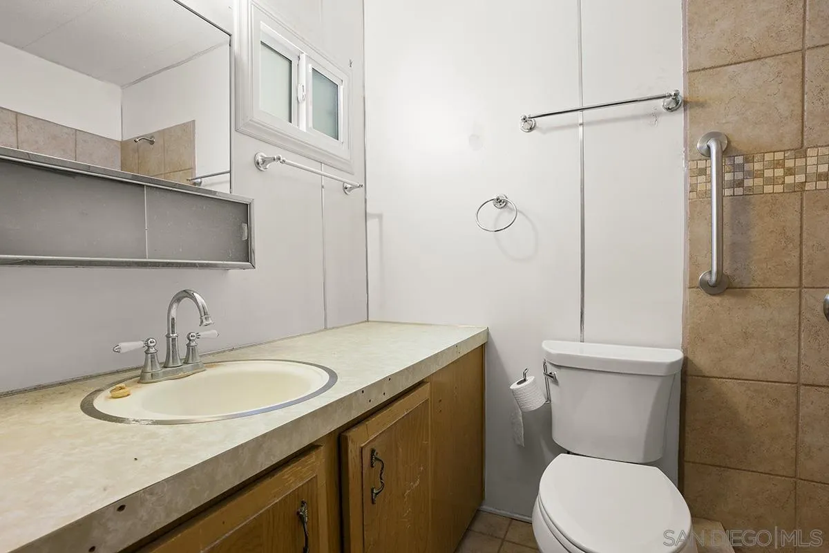 8545 Mission Gorge Road, Unit 239 Santee, CA 92071 - Photo 23 of 26 a bathroom with a sink toilet and shower