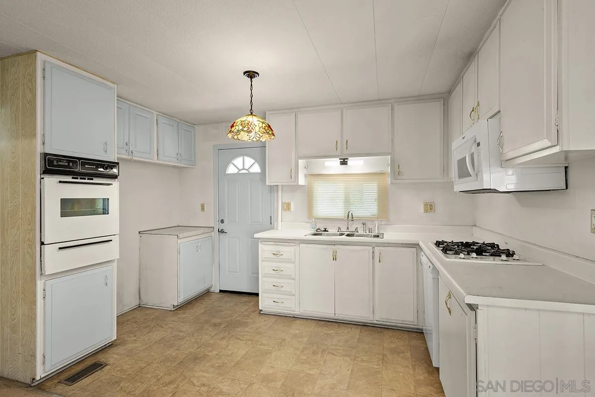 8545 Mission Gorge Road, Unit 239 Santee, CA 92071 - Photo 10 of 26 a kitchen with stainless steel appliances a sink stove and refrigerator