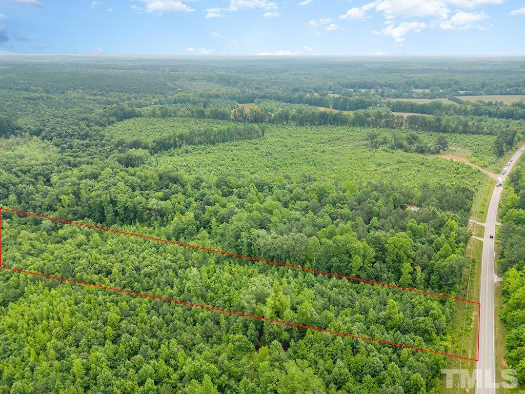 a view of a green field with lots of bushes