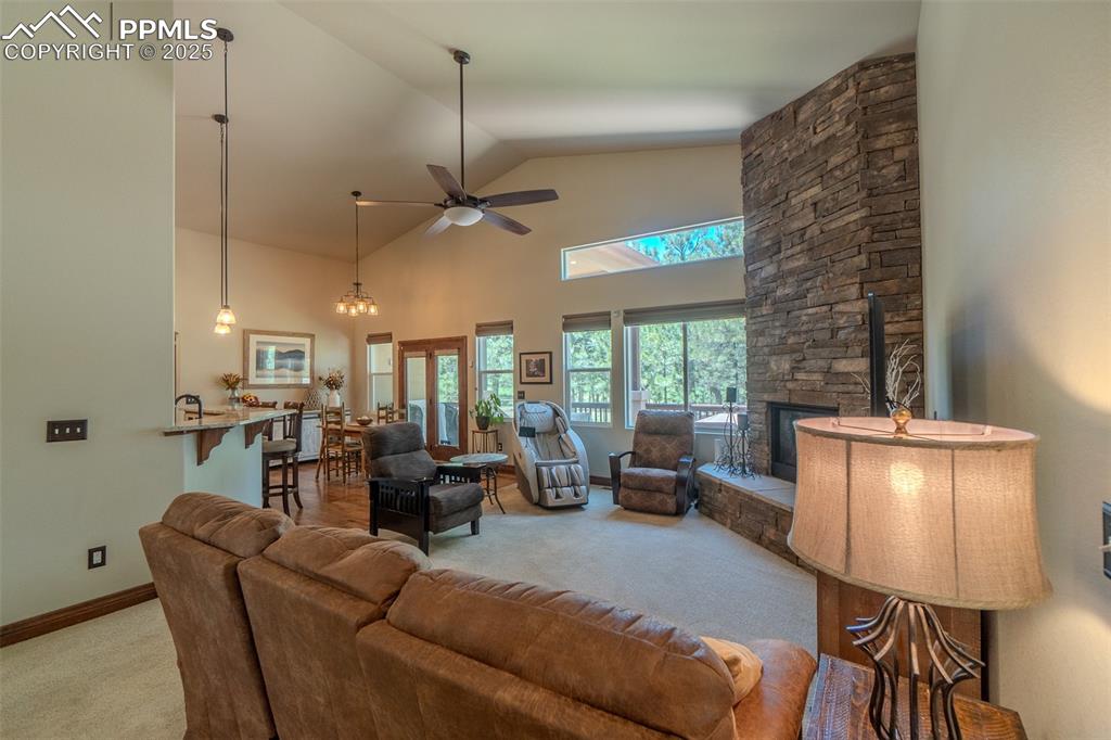 15324 Pole Pine Point Colorado Springs, CO 80908 - Photo 11 of 50 a living room with furniture and a chandelier