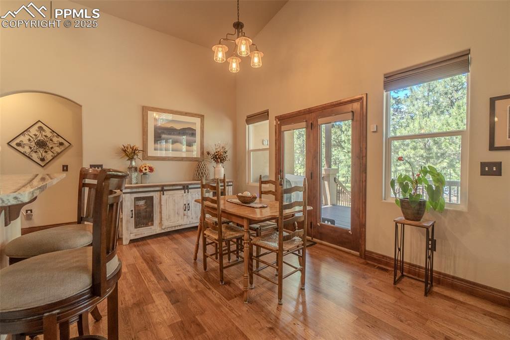 15324 Pole Pine Point Colorado Springs, CO 80908 - Photo 12 of 50 a view of a dining room with furniture window and wooden floor