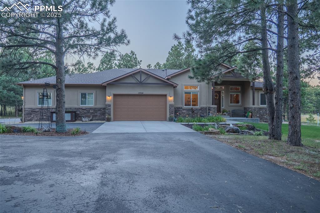 15324 Pole Pine Point Colorado Springs, CO 80908 - Photo 2 of 50 a view of a house with a yard and large tree