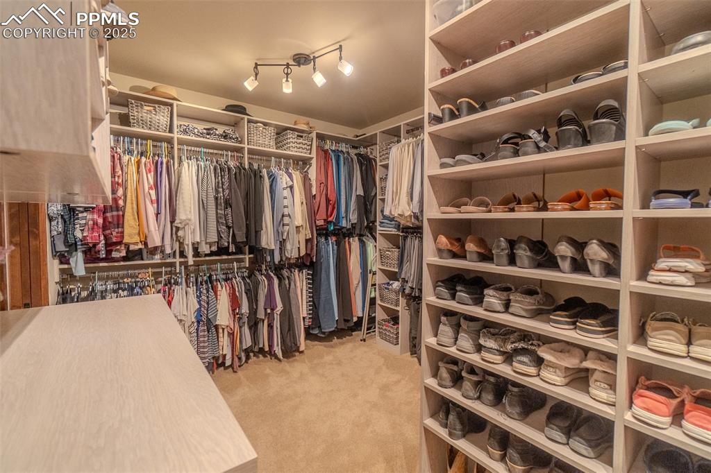 15324 Pole Pine Point Colorado Springs, CO 80908 - Photo 23 of 50 a view of walk in closet with clothes and shoes