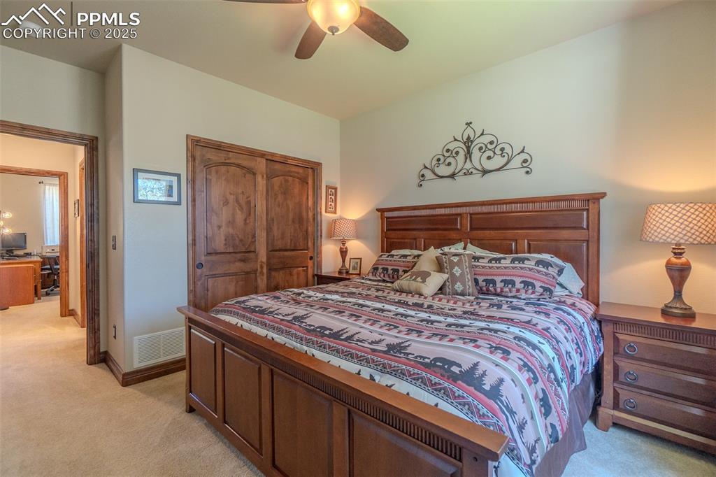 15324 Pole Pine Point Colorado Springs, CO 80908 - Photo 26 of 50 a bedroom with a bed and a chandelier