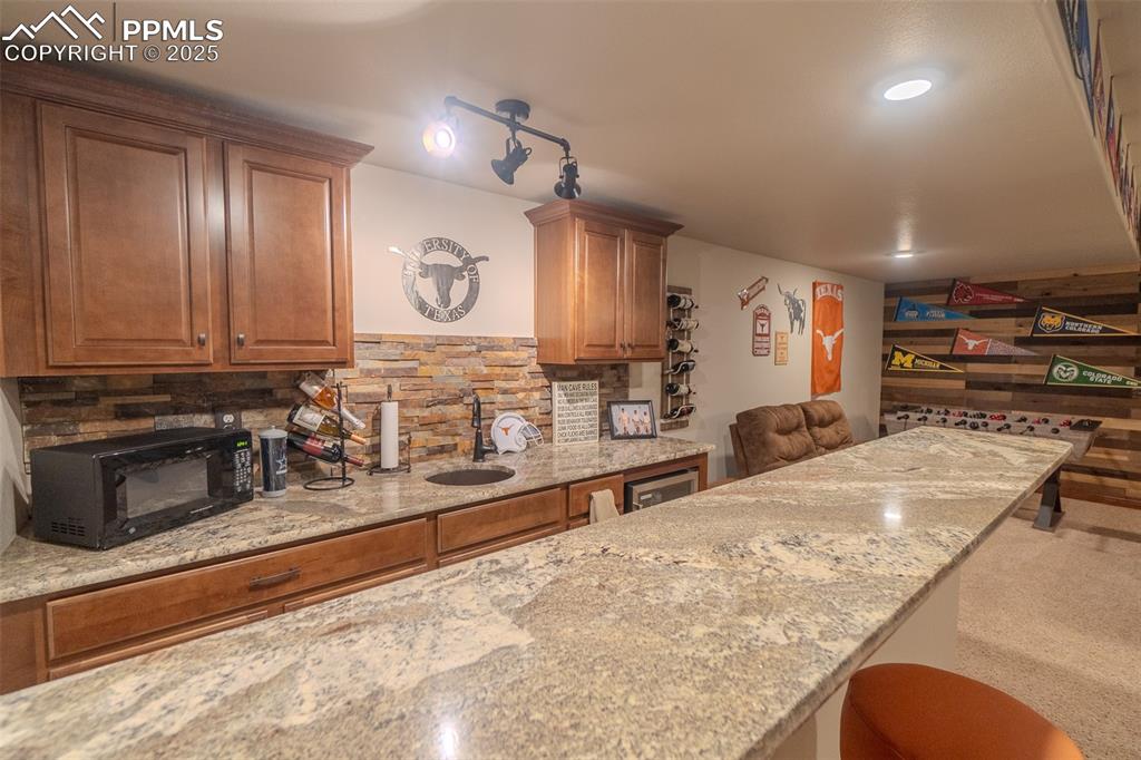 15324 Pole Pine Point Colorado Springs, CO 80908 - Photo 33 of 50 a kitchen with stainless steel appliances granite countertop a stove and a sink with granite countertops