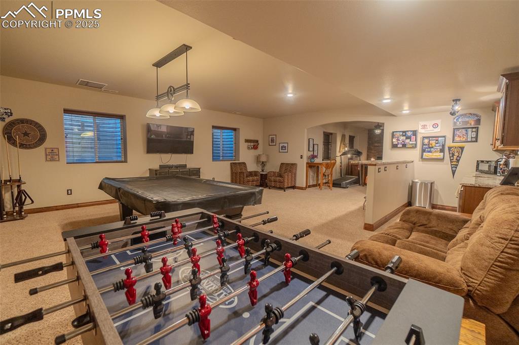 15324 Pole Pine Point Colorado Springs, CO 80908 - Photo 35 of 50 a living room filled with furniture and a chandelier