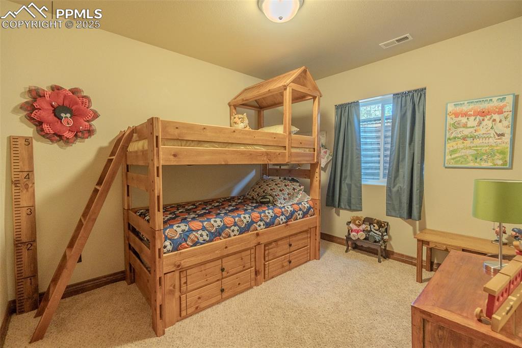 15324 Pole Pine Point Colorado Springs, CO 80908 - Photo 37 of 50 a bedroom with a bed and a baby crib