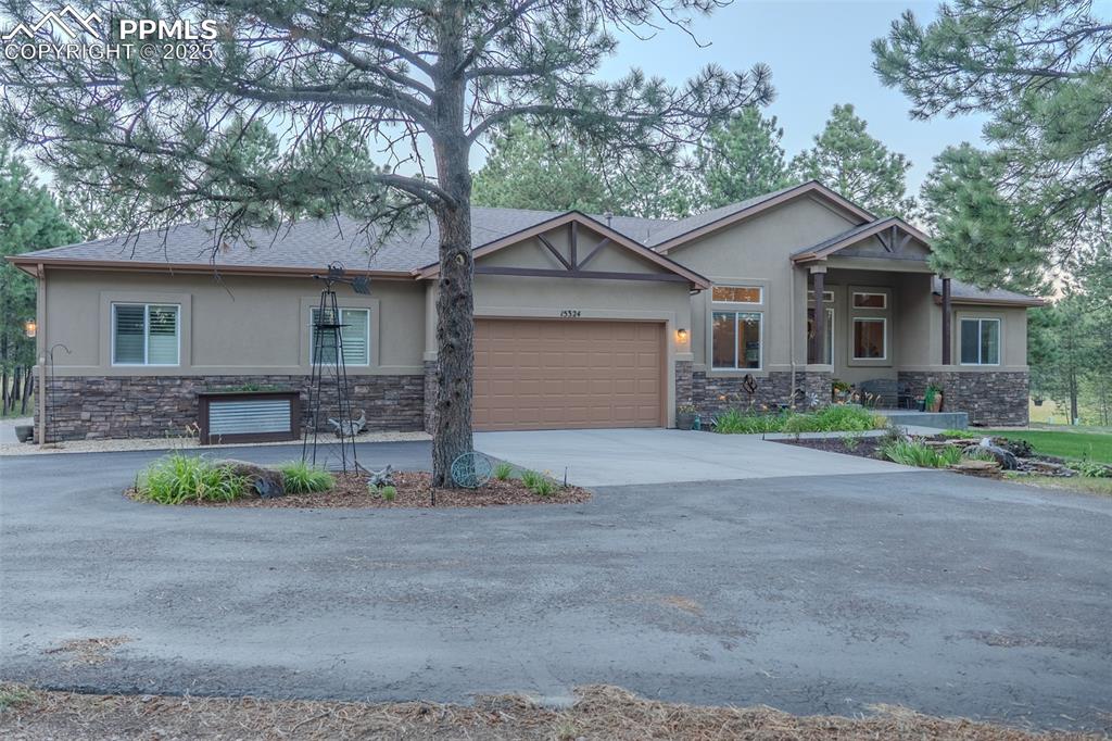 15324 Pole Pine Point Colorado Springs, CO 80908 - Photo 4 of 50 a front view of house with a garden