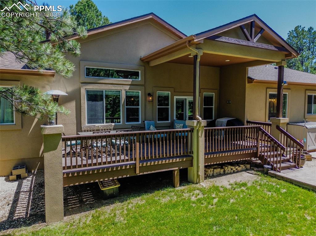 15324 Pole Pine Point Colorado Springs, CO 80908 - Photo 44 of 50 a view of a house with a yard and a deck