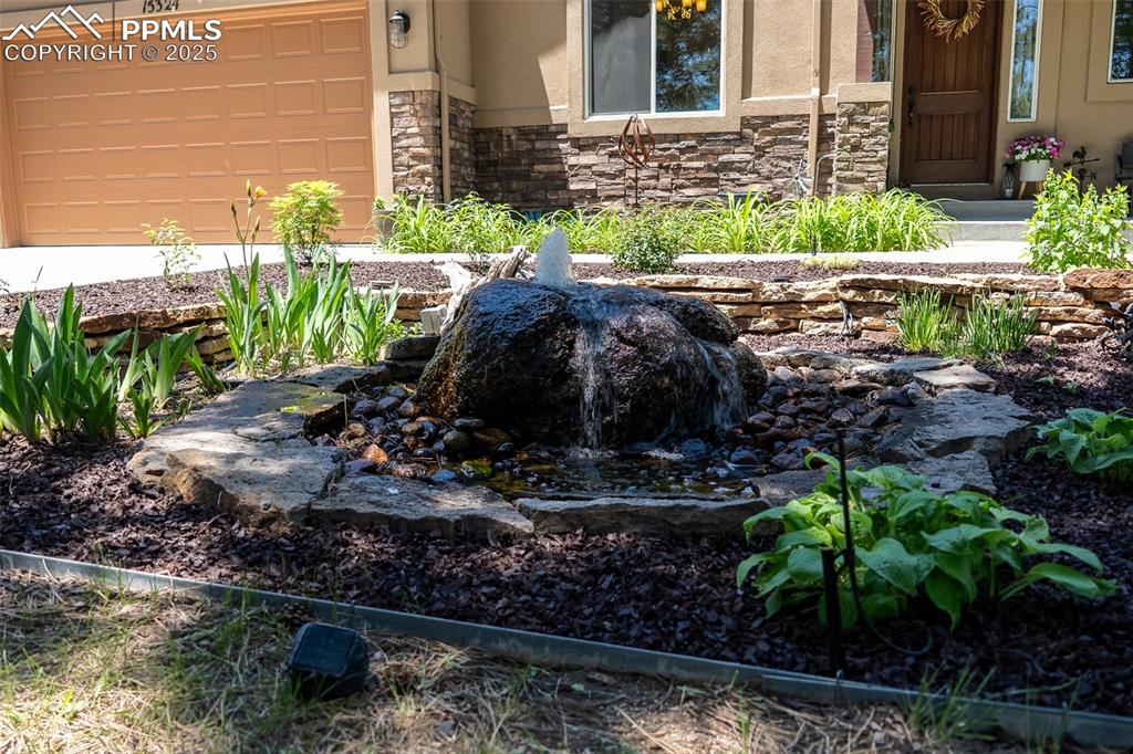 15324 Pole Pine Point Colorado Springs, CO 80908 - Photo 7 of 50 a view of a garden with a bench in back yard