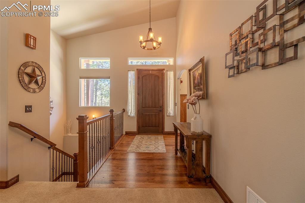 15324 Pole Pine Point Colorado Springs, CO 80908 - Photo 8 of 50 a view of a hallway with wooden floor and entryway