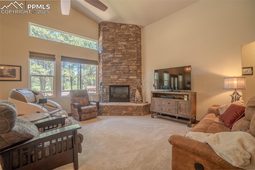 15324 Pole Pine Point Colorado Springs, CO 80908 - Photo 9 of 50 a living room with furniture a flat screen tv and a fireplace