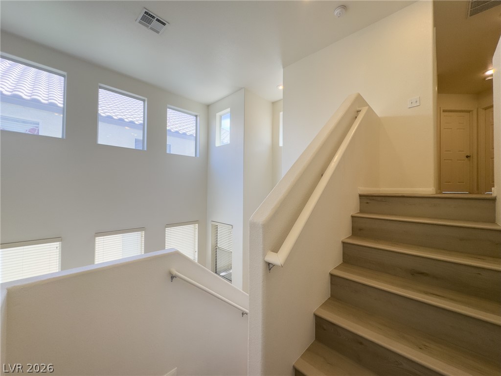 9456 Grandview Spring Avenue Las Vegas, NV 89166 - Photo 20 of 49 Cascading natural light illuminates this impressive two-story foyer and staircase.