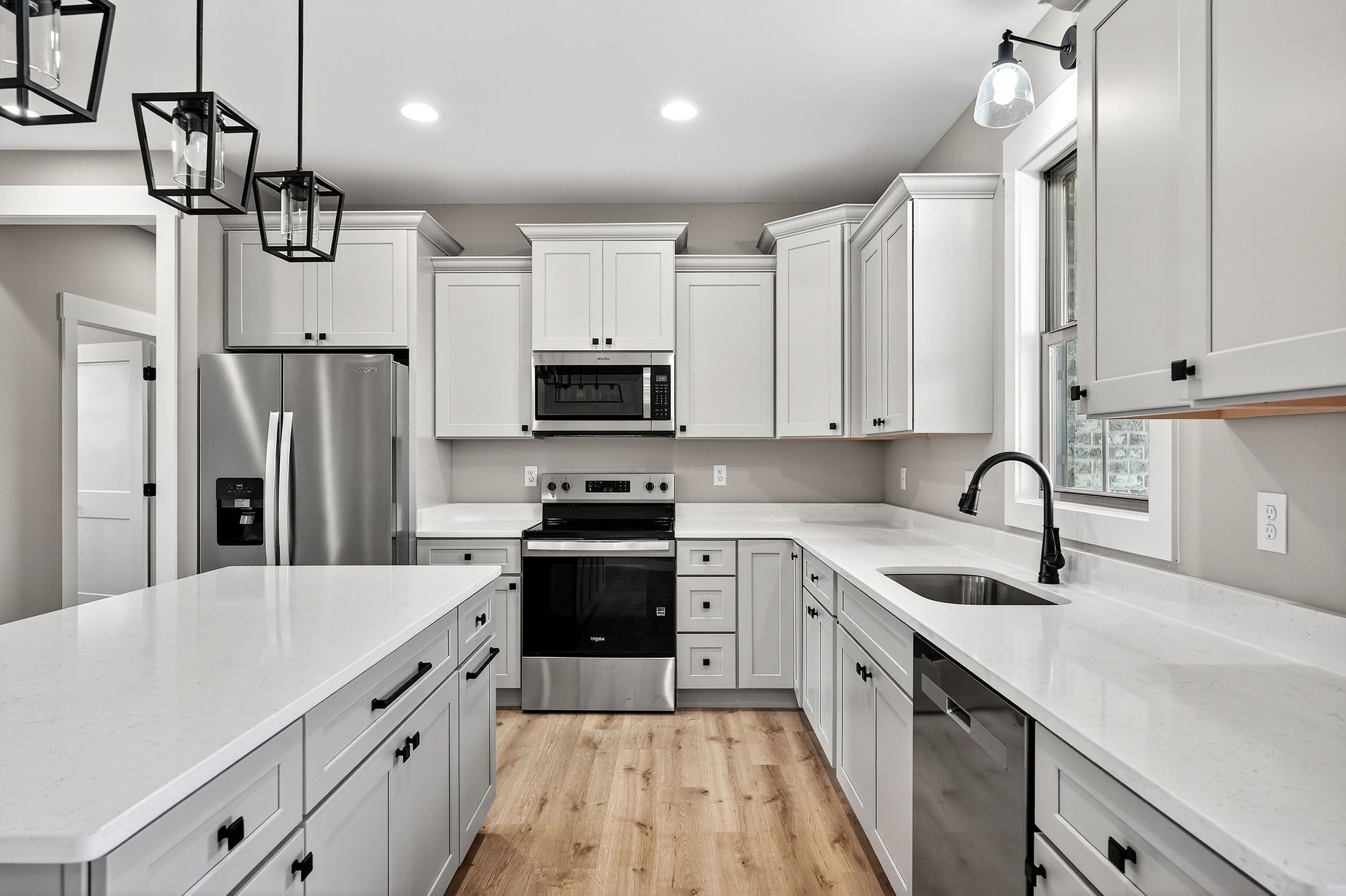 136 East McCormick Road Livingston, TN 38570 - Photo 11 of 29 a kitchen with stainless steel appliances a sink dishwasher a refrigerator and cabinets with wooden floor