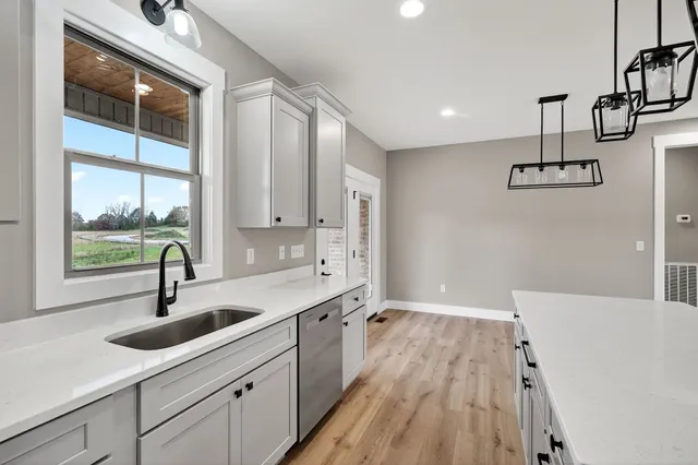 a kitchen with sink and window