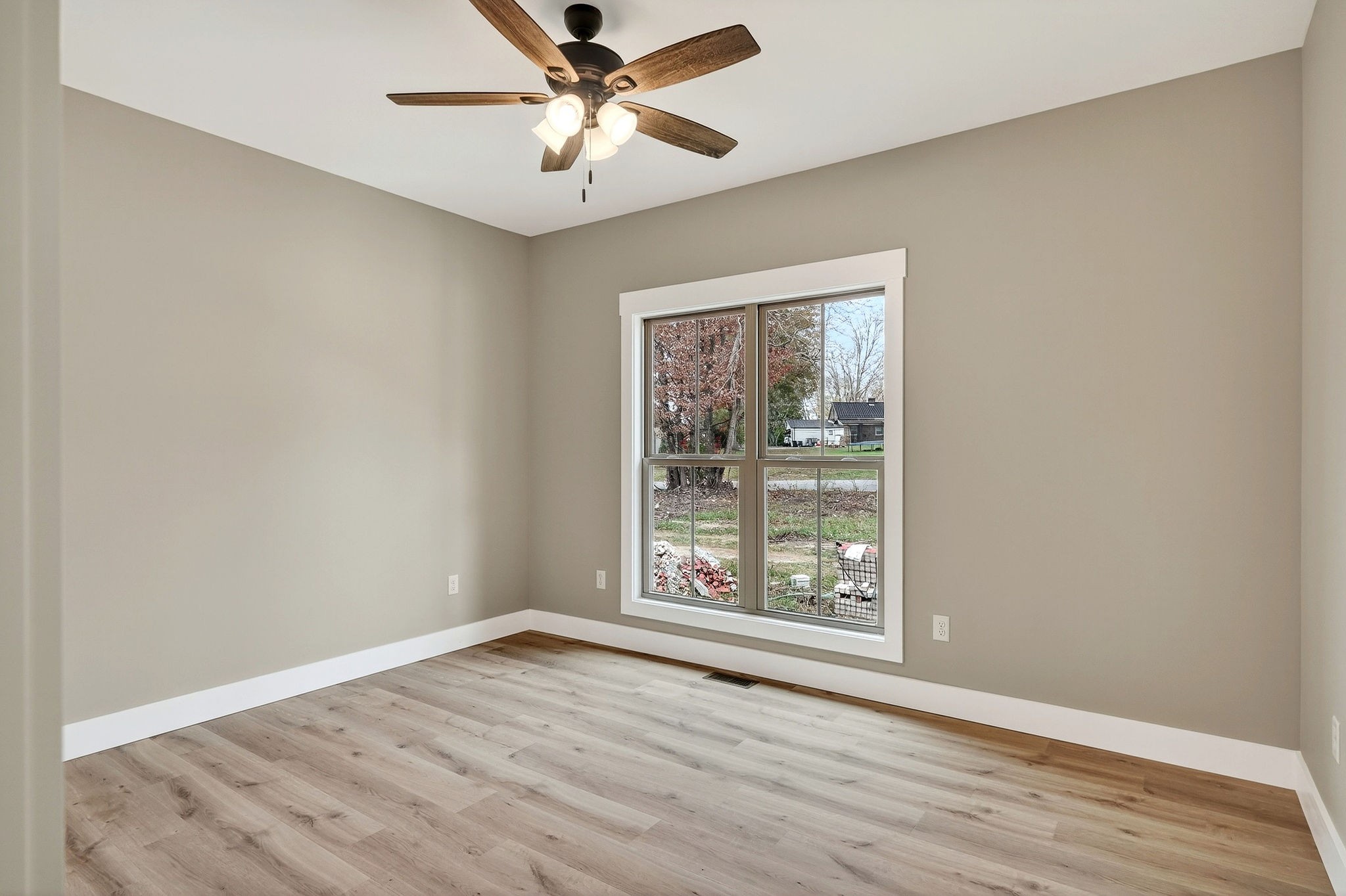 136 East McCormick Road Livingston, TN 38570 - Photo 23 of 29 an empty room with wooden floor chandelier fan and windows