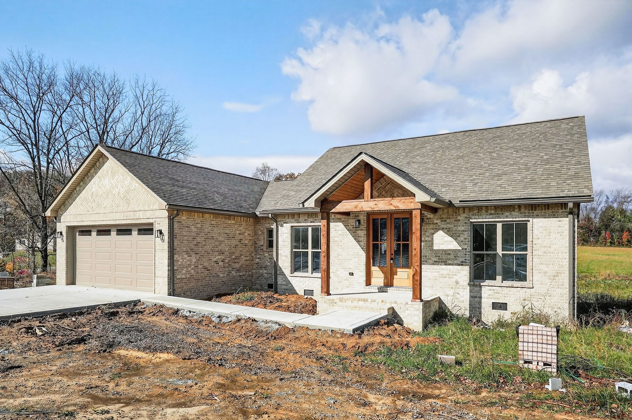 136 East McCormick Road Livingston, TN 38570 - Photo 3 of 29 a front view of a house with a yard and garage