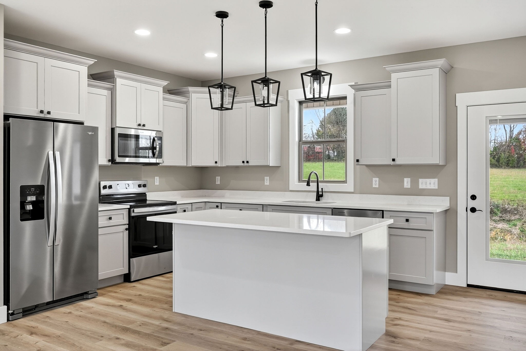 136 East McCormick Road Livingston, TN 38570 - Photo 9 of 29 a kitchen with stainless steel appliances granite countertop a sink a stove a refrigerator and island with wooden floor