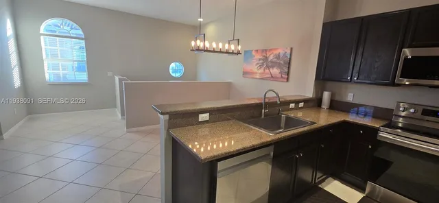 a kitchen with refrigerator and microwave