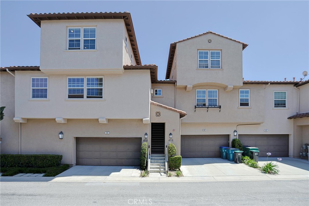 416 Quail Ridge Irvine, CA 92603 - Photo 2 of 23 a front view of a house with a yard and garage