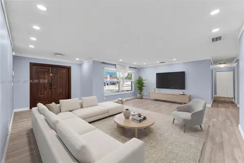 a living room with furniture and a flat screen tv