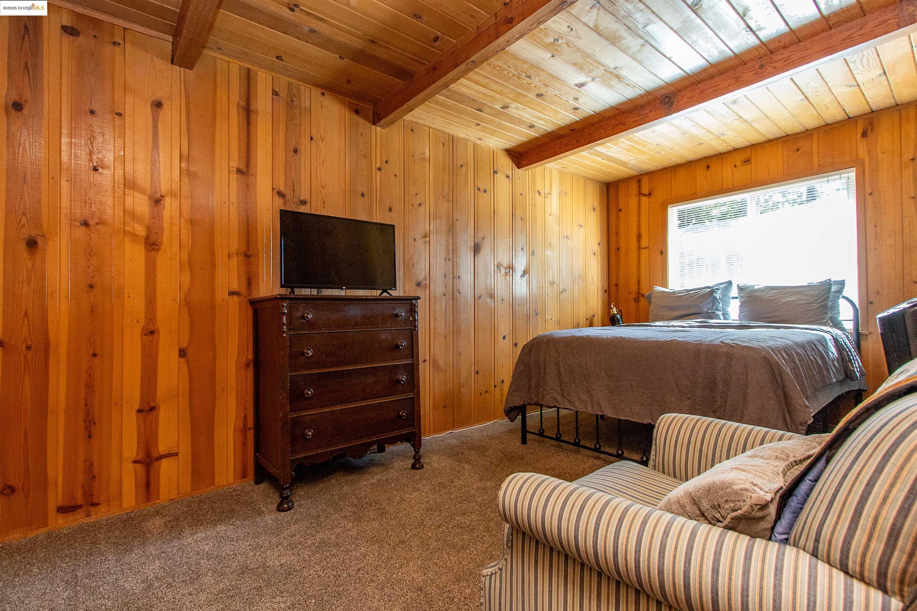 20737 Muheli Road Mi Wuk Village, CA 95346 - Photo 13 of 40 a bedroom with furniture and a flat screen tv