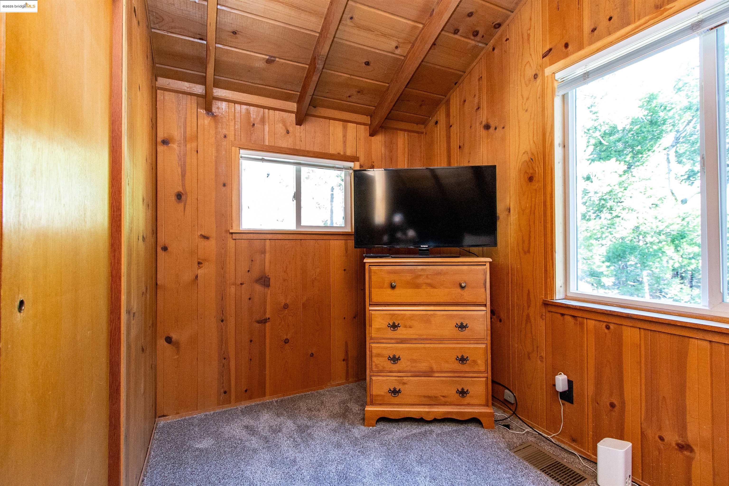 20737 Muheli Road Mi Wuk Village, CA 95346 - Photo 20 of 40 a view of room with window and flat screen tv