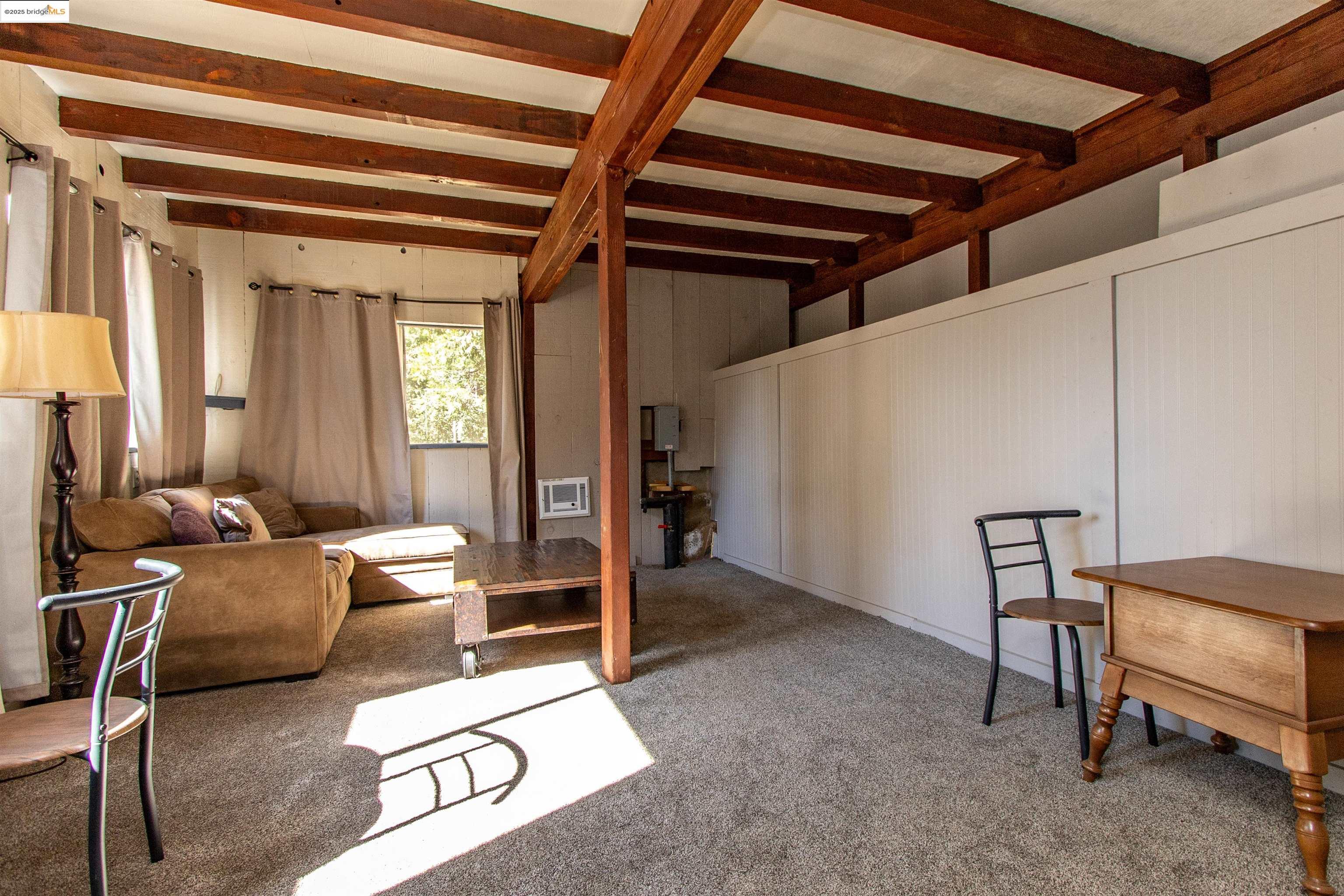 20737 Muheli Road Mi Wuk Village, CA 95346 - Photo 21 of 40 a living room with furniture and a window