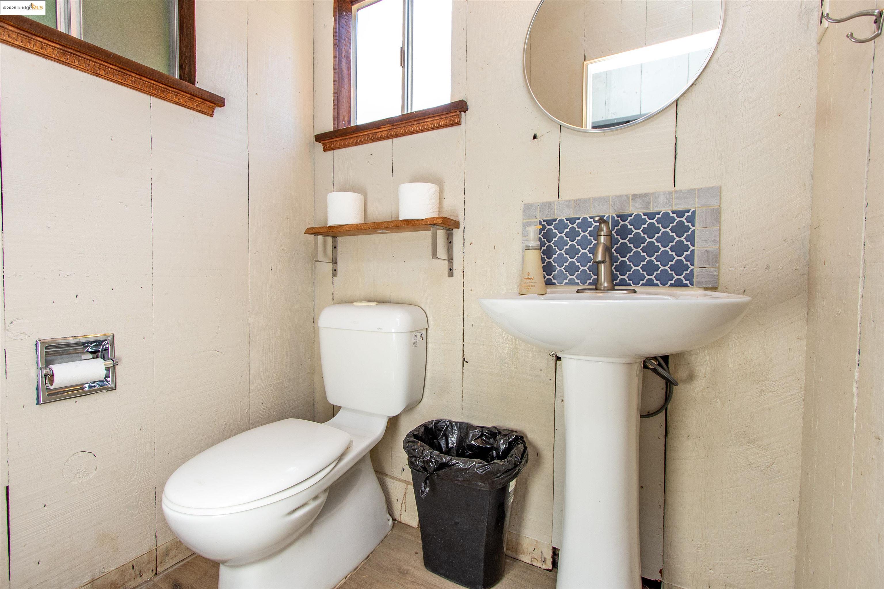 20737 Muheli Road Mi Wuk Village, CA 95346 - Photo 23 of 40 a bathroom with a toilet sink and mirror