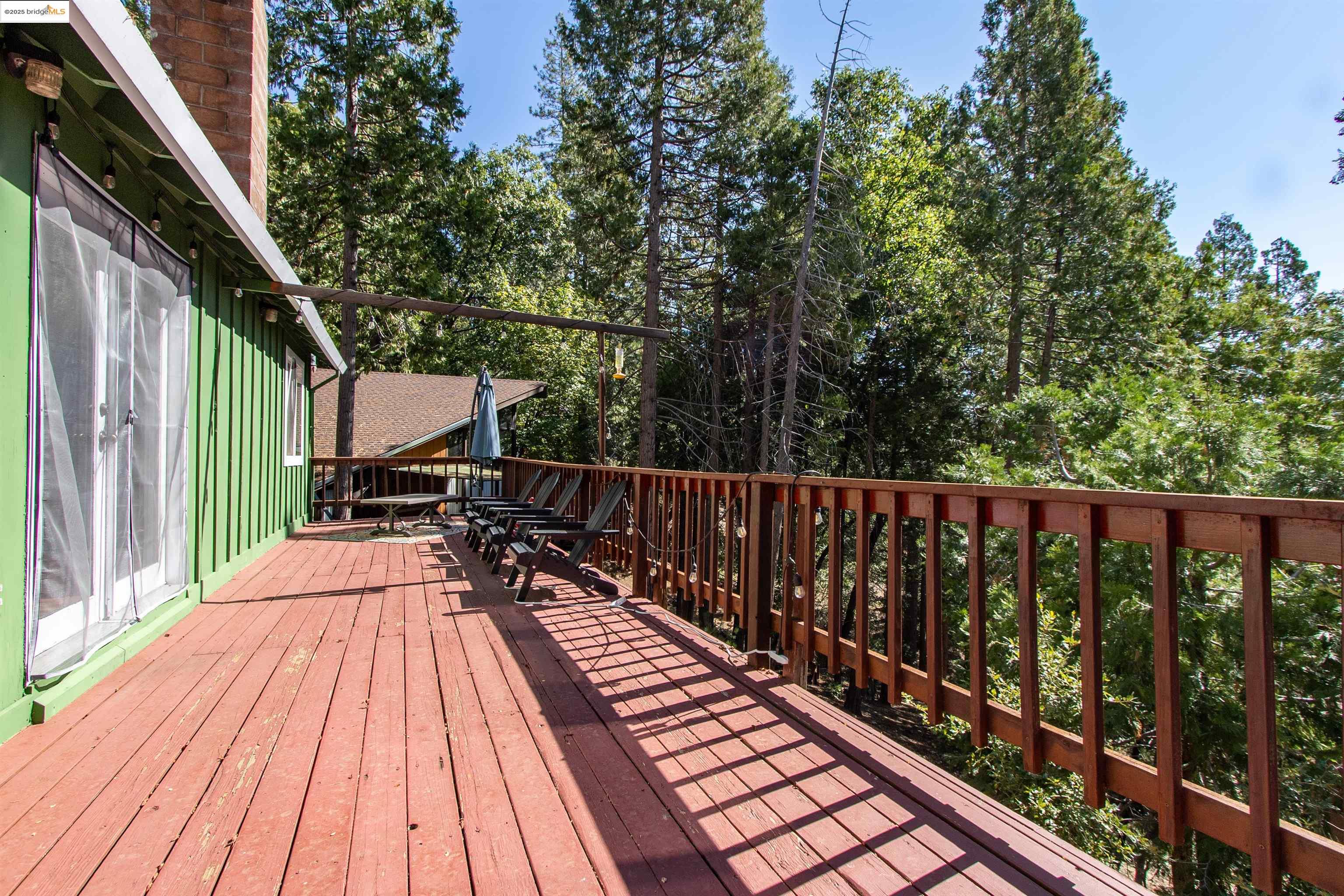 20737 Muheli Road Mi Wuk Village, CA 95346 - Photo 31 of 40 a balcony with wooden floor and outdoor seating