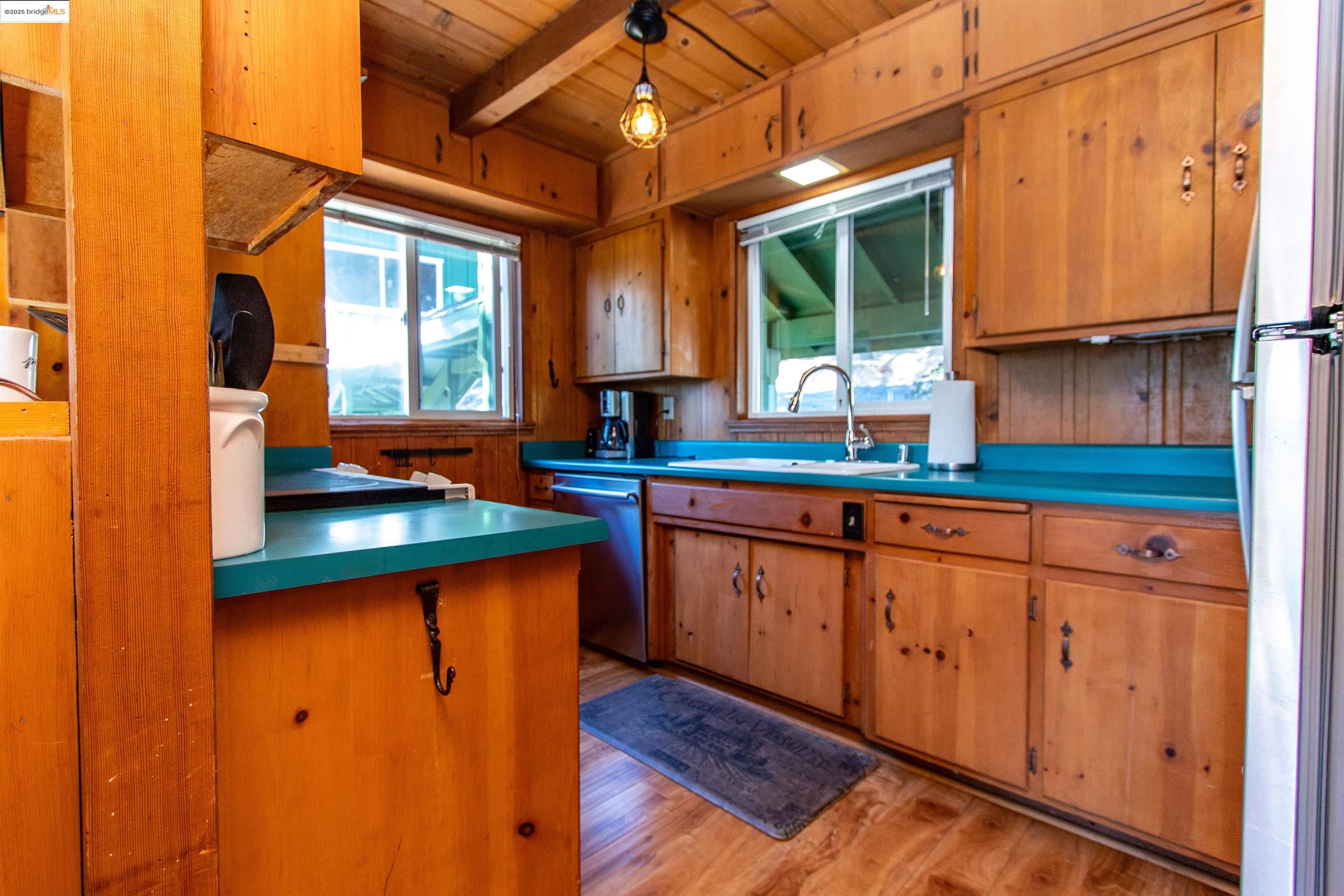 20737 Muheli Road Mi Wuk Village, CA 95346 - Photo 5 of 40 a kitchen with stainless steel appliances granite countertop wooden cabinets a sink a window and a counter space