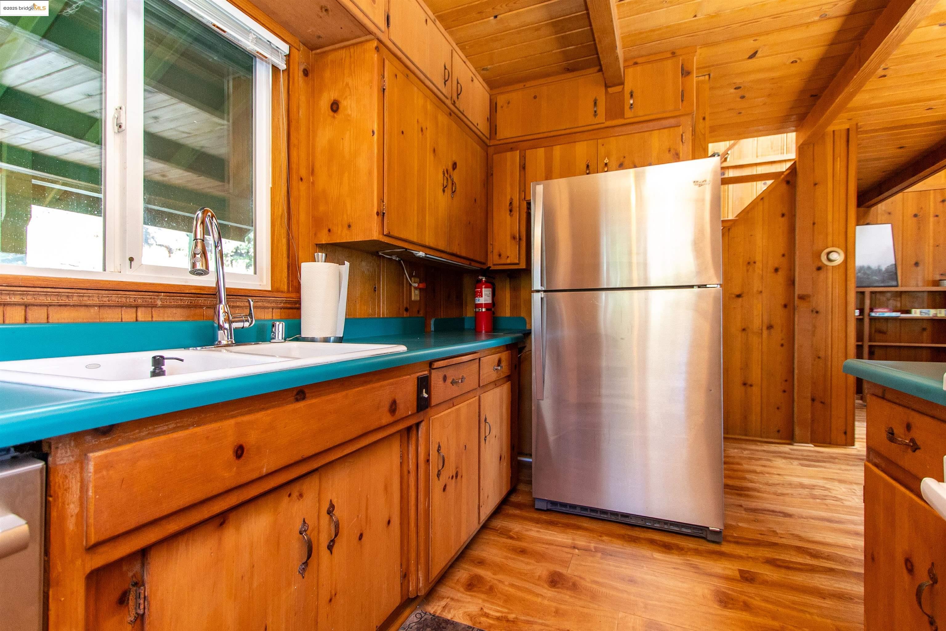 20737 Muheli Road Mi Wuk Village, CA 95346 - Photo 7 of 40 a kitchen with stainless steel appliances a refrigerator and a sink