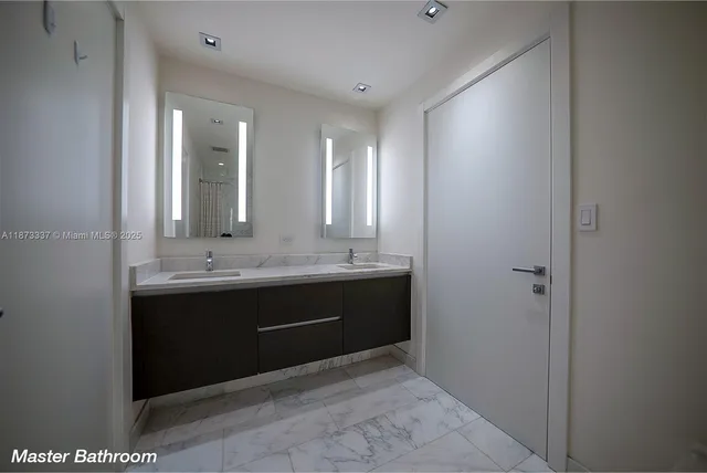 a bathroom with a granite countertop bathtub and a toilet
