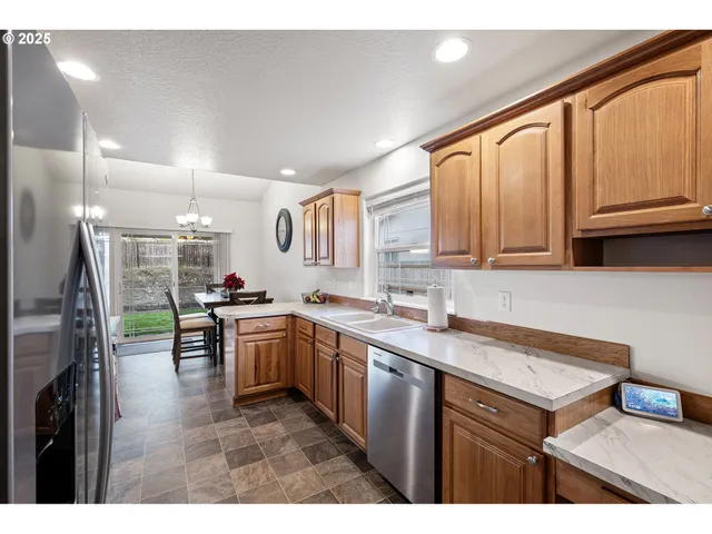 a kitchen with a sink window and cabinets