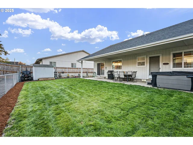 a view of a house with a backyard porch and sitting area