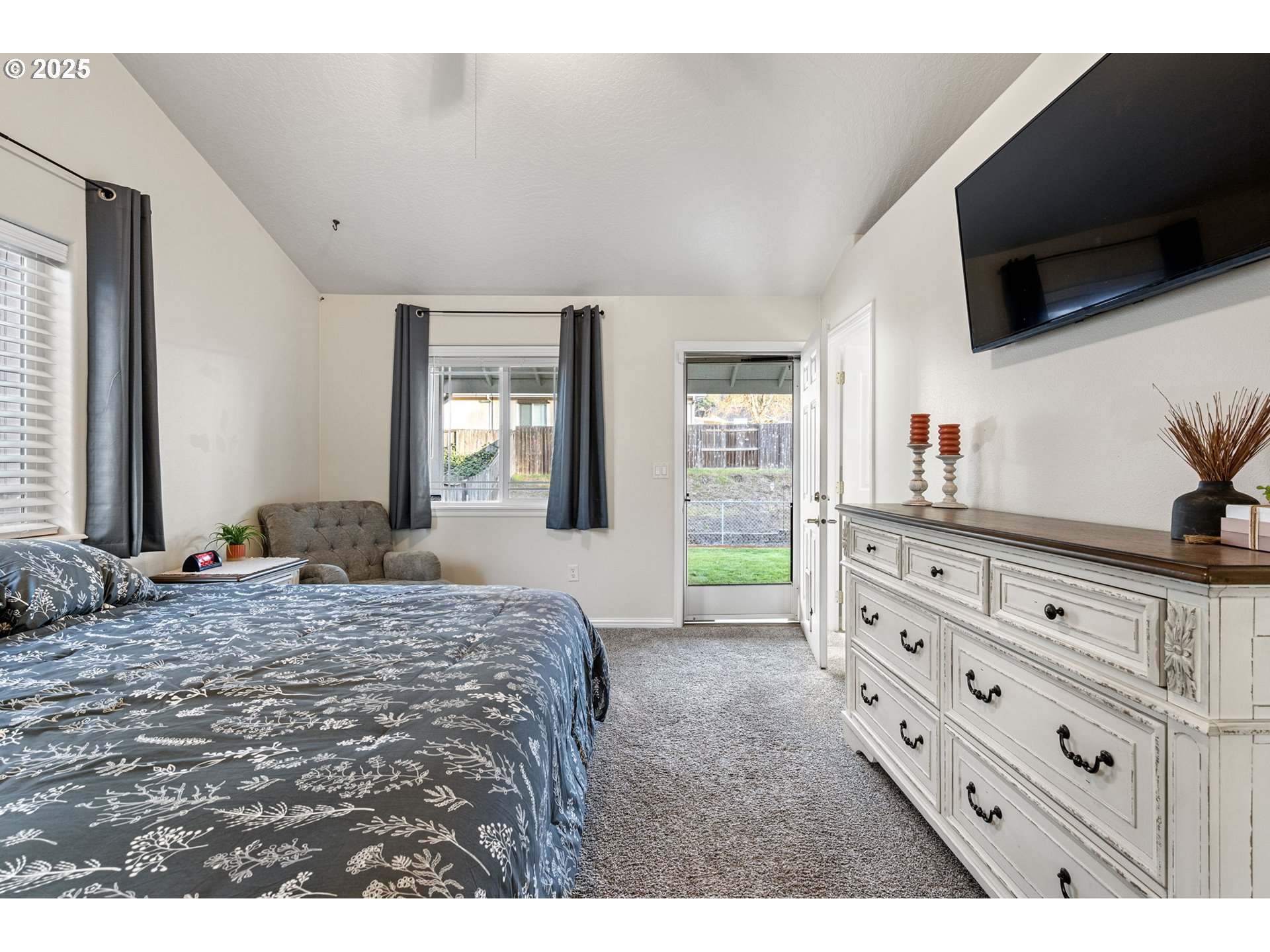 1904 South 6th Street Cottage Grove, OR 97424 - Photo 21 of 37 a bedroom with a bed and a flat tv screen on dresser
