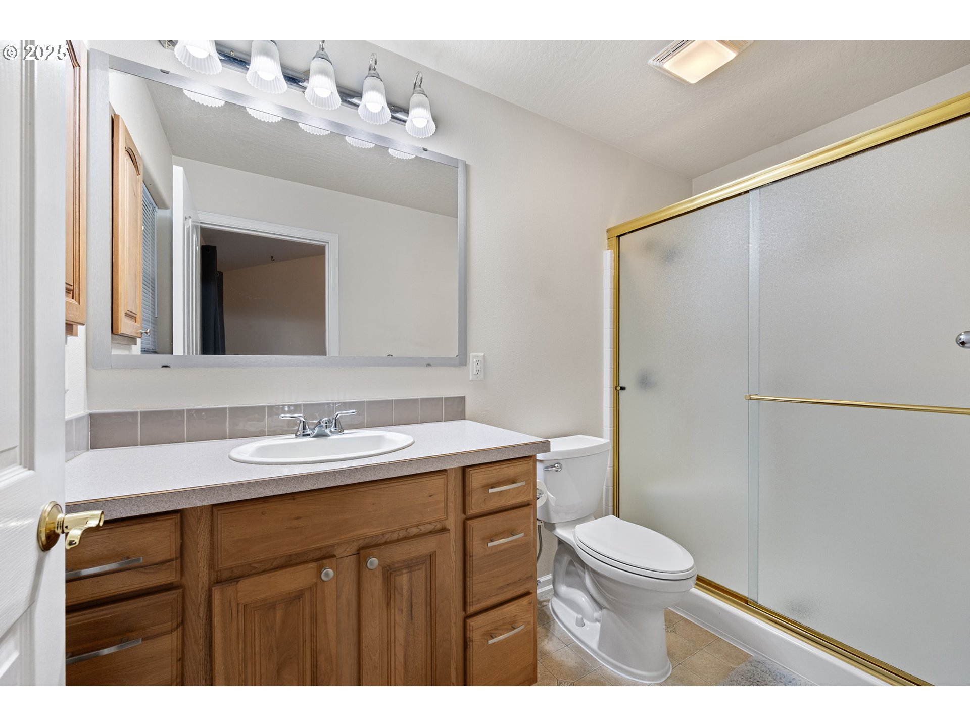 1904 South 6th Street Cottage Grove, OR 97424 - Photo 25 of 37 a bathroom with a sink vanity mirror and toilet