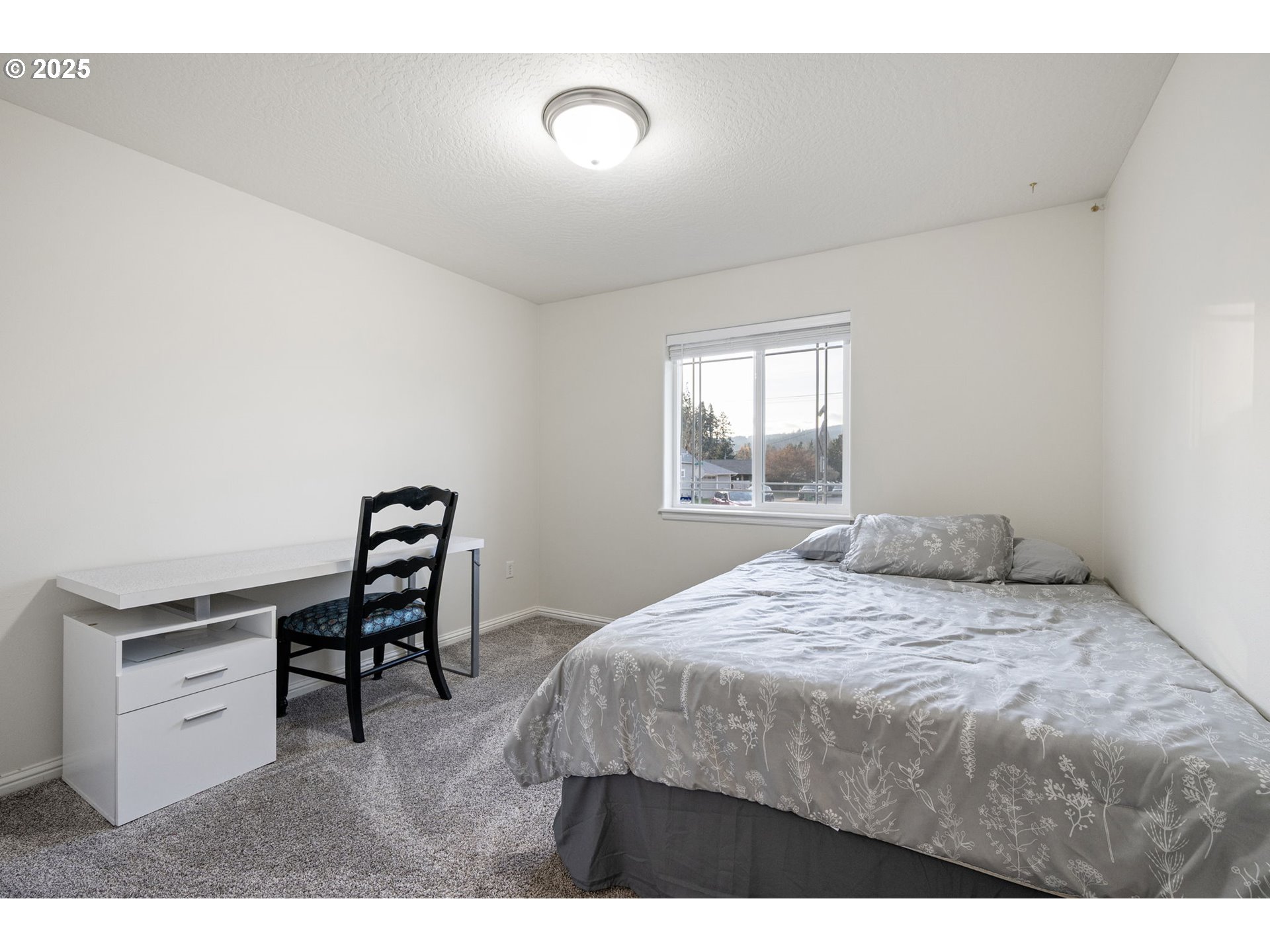 1904 South 6th Street Cottage Grove, OR 97424 - Photo 31 of 37 a bedroom with a bed and a window