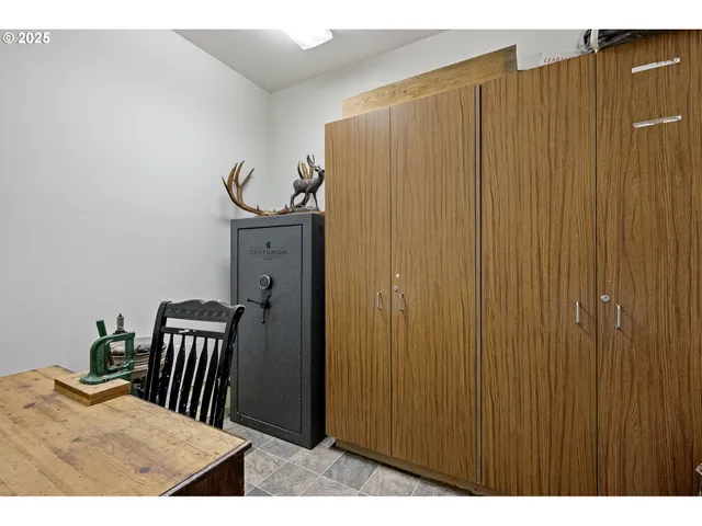 a view of a bedroom with a table and chair