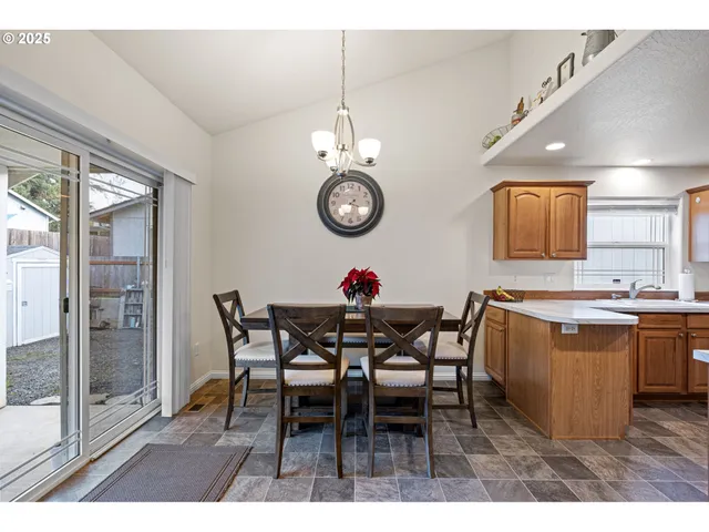 a dining room with a wooden table and chairs