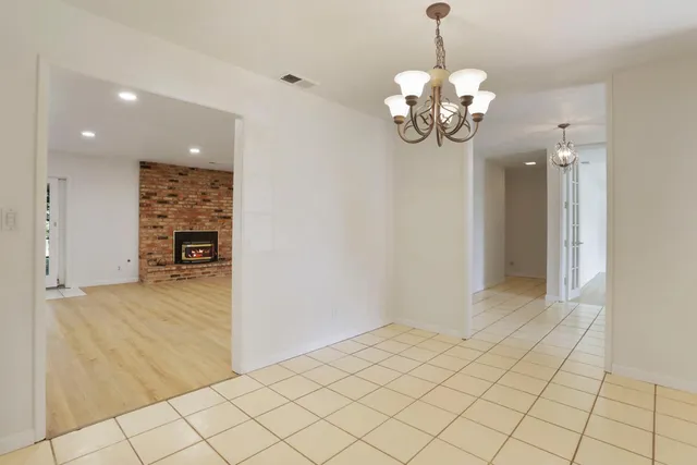 an empty room with wooden floor and a window